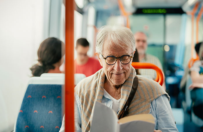 man reading on a bus