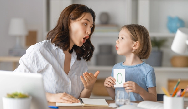 mother teaching daughter at home