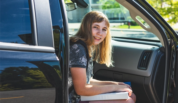 girl in car with the door open