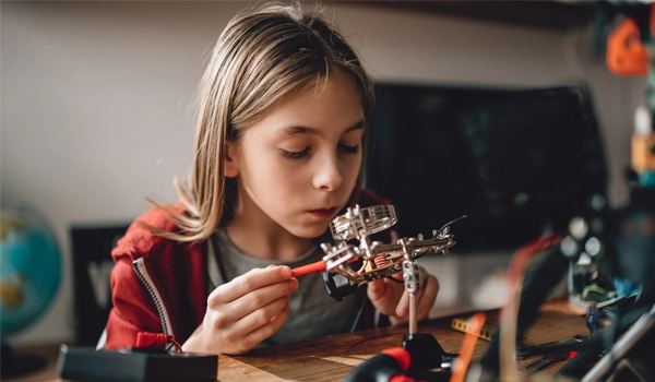 young girl working on a STEM Kit