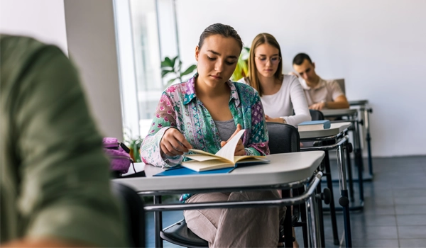 teens in a classroom reading the same books