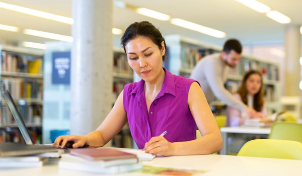 woman having her test administered in the library