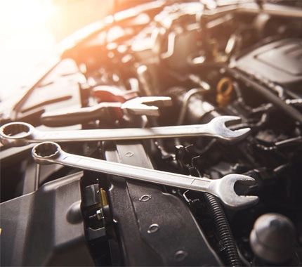 wrenches on a car engine