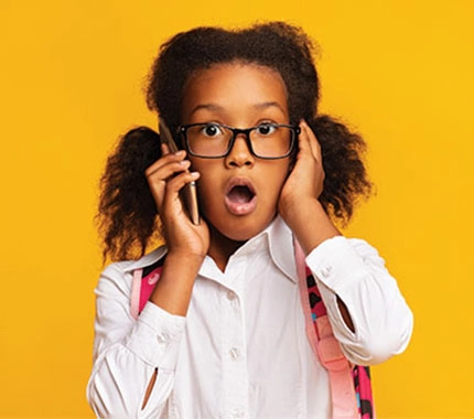 A young girl listening on a phone