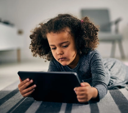 child reading on their device