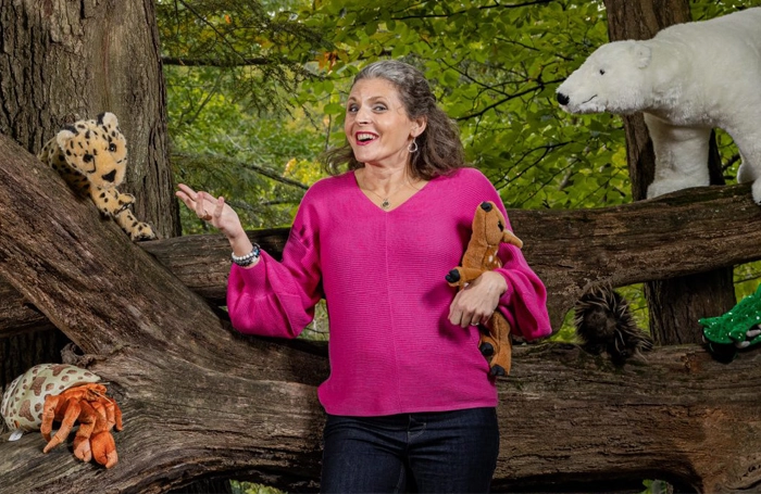 author/storyteller Lindsay Bonilla talking to a bunch of stuffed animals