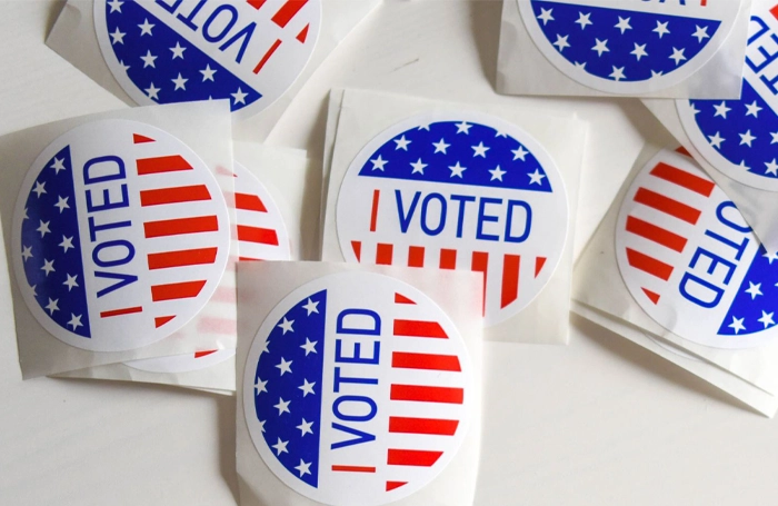 a pile of voter registration stickers